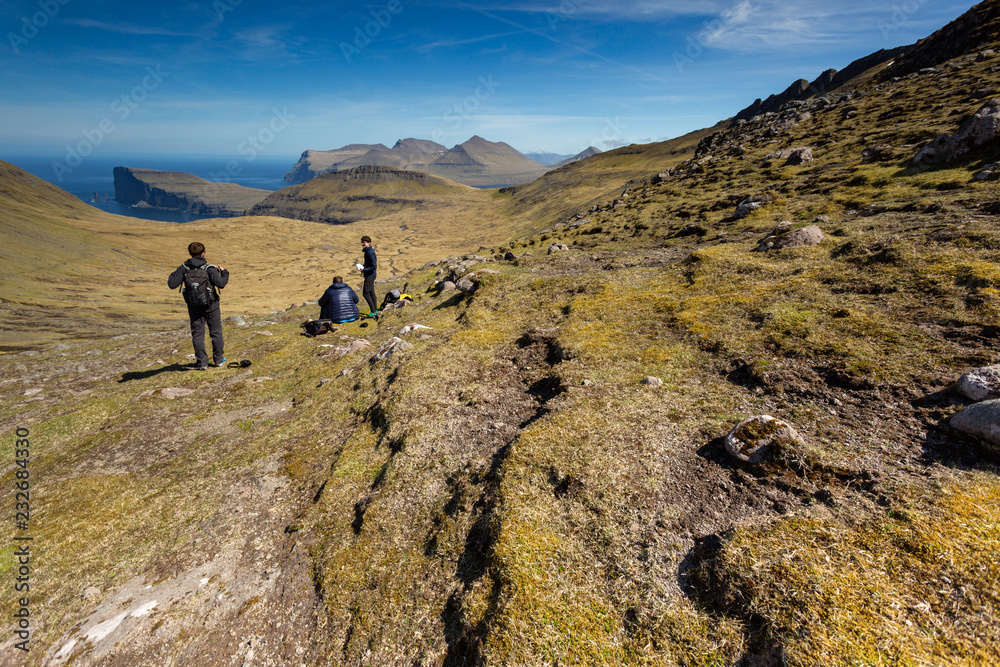 Group of friends exploring the never ending highlands in the Faroe Islands