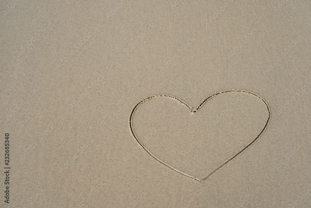valentines day heart drawn on the sand beach