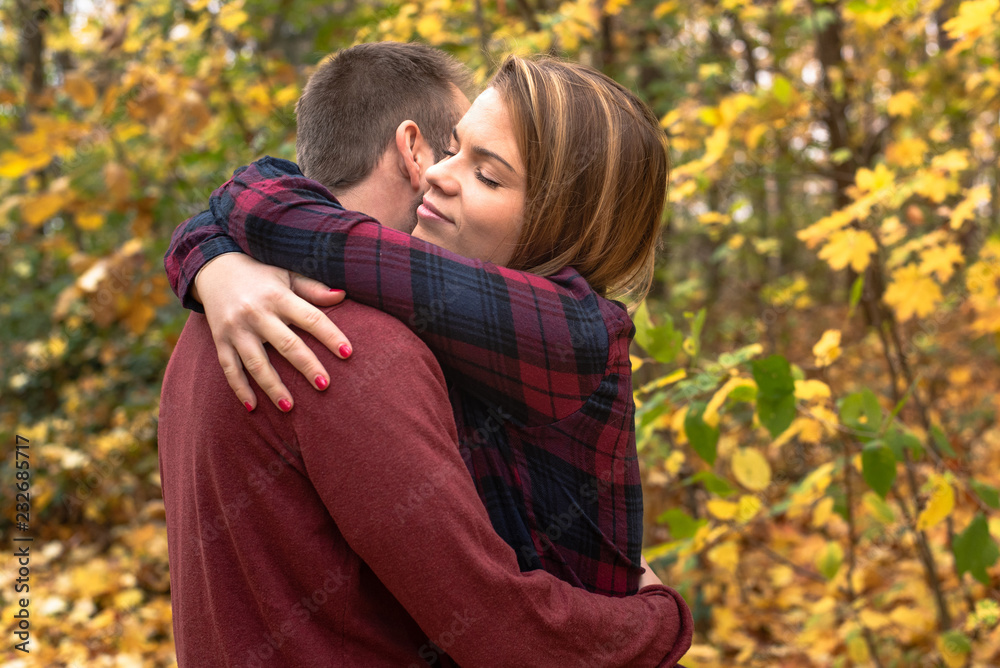 Fototapeta premium A beautiful girl hugs her boyfriend. Couple in love.