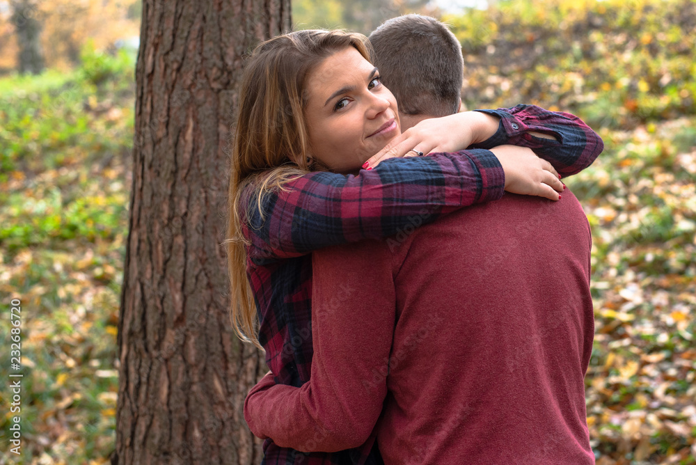 A beautiful girl hugs her boyfriend. Couple in love. A beautiful girl hugs her boyfriend. Couple in love.