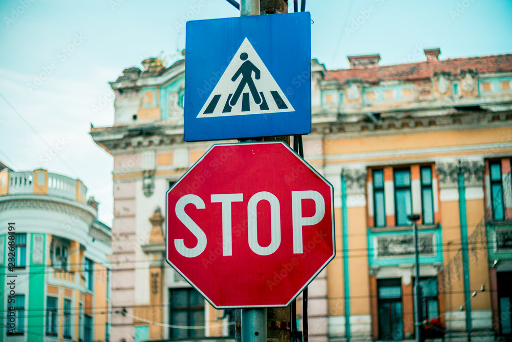 Pedestrian crosswalk road sign with additional stop sign