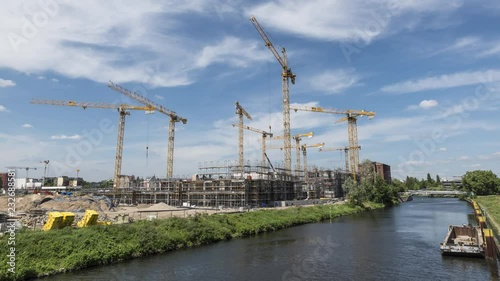 Operating cranes at building site, timelapse