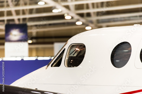 Photos Closeup high detailed view on illuminators of passenger aircraft standing on parking place at airport hangar