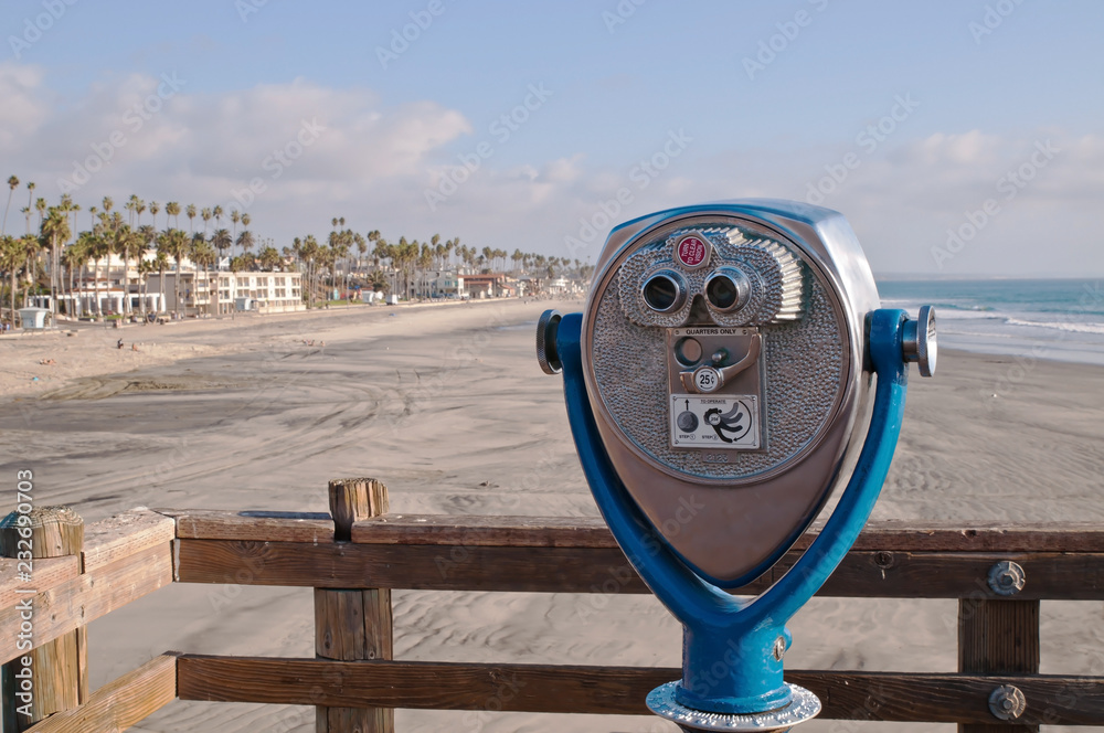 Coin-operated Binoculars overlooking the beach from a pier in Oceanside, California, USA Coin-operated Binoculars overlooking the beach from a pier in Oceanside, California, USA