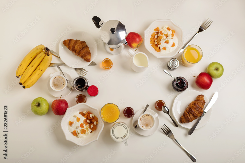 Breakfast time. Croissants and orange juice, jam and honey. Coffee with cream or milk. Fruits - bananas, red and green apples. Ricotta with sour cream, nuts and dried apricots. Breakfast time. Croissants and orange juice, jam and honey. Coffee with cream or milk. Fruits - bananas, red and green apples. Ricotta with sour cream, nuts and dried apricots.