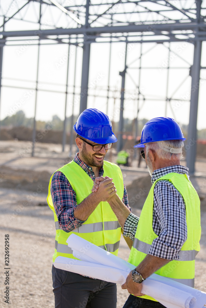 Engineers shaking hands on construction site Engineers shaking hands on construction site