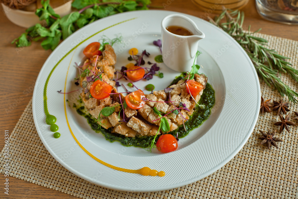 meat ragout with tomatoes in a white dish on a wooden table meat ragout with tomatoes in a white dish on a wooden table