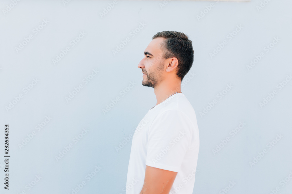 Side view of young bearded man isolated on blue background Side view of young bearded man isolated on blue background