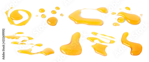 Set with honey drops on white background