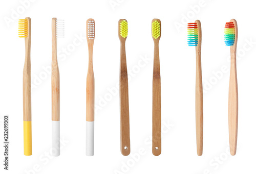 Set with bamboo toothbrushes on white background