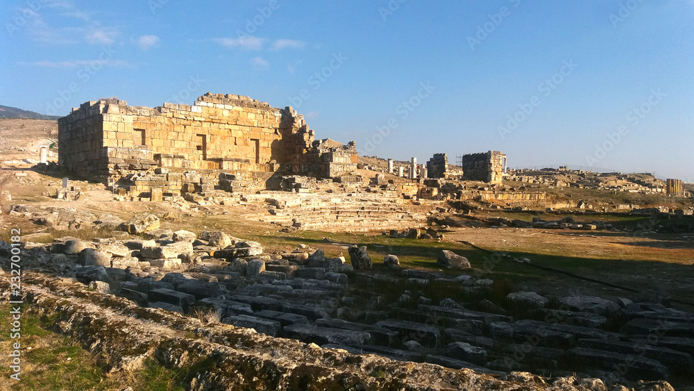 Ruins at Hieropolis near Pamukkale, Denizli in a golden evening sunlight, with bright blue skies. 