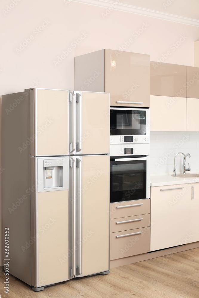 Fototapeta premium Interior of spacious modern kitchen with refrigerator
