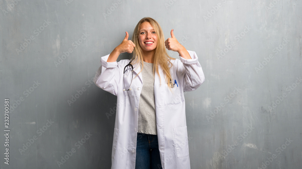 Young doctor woman giving a thumbs up gesture and smiling because has had success Young doctor woman giving a thumbs up gesture and smiling because has had success