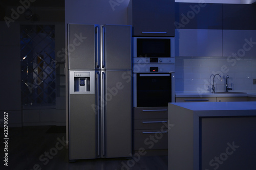 Kitchen interior with four door refrigerator at night