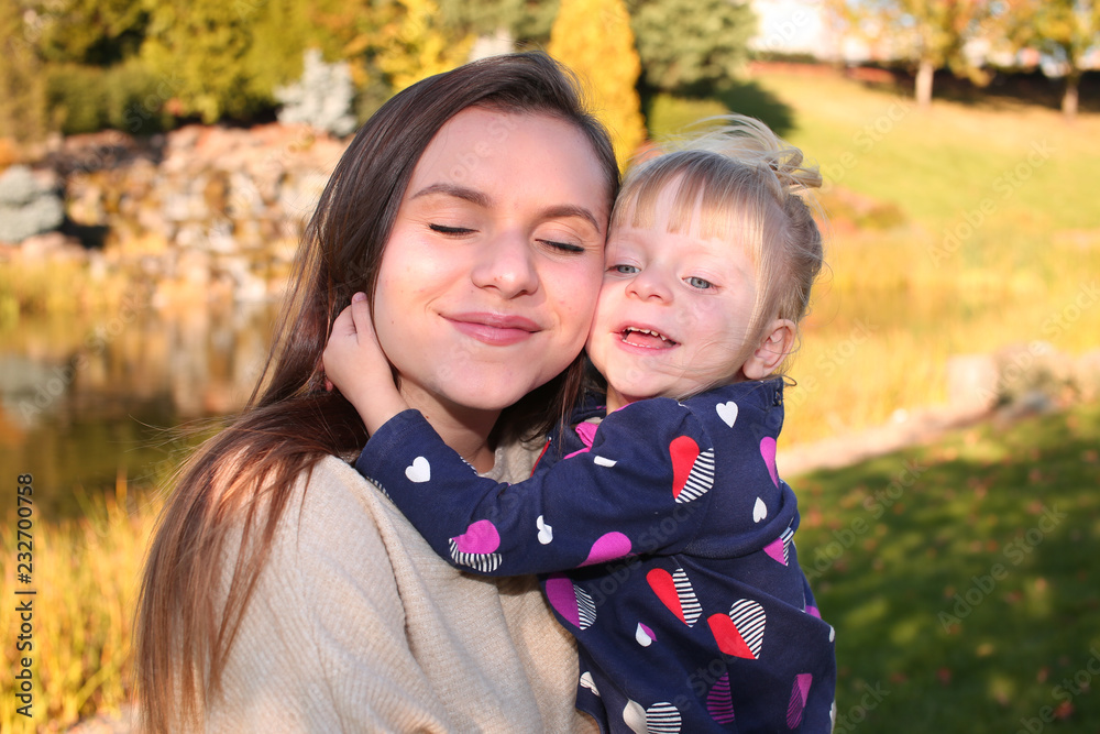 Close up, Portrait, Two Beautiful Happy Sisters, in the park in the open air, Golden Autumn Background Close up, Portrait, Two Beautiful Happy Sisters, in the park in the open air, Golden Autumn Background