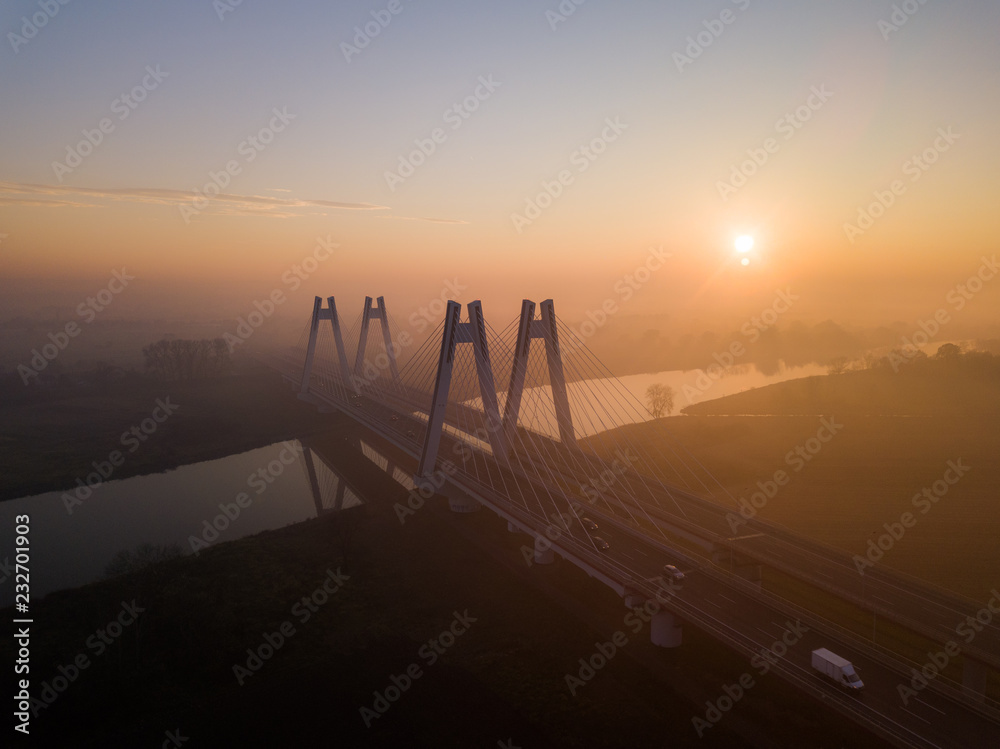 Obraz premium foggy bridge on the Vistula at sunset, Krakow, Poland