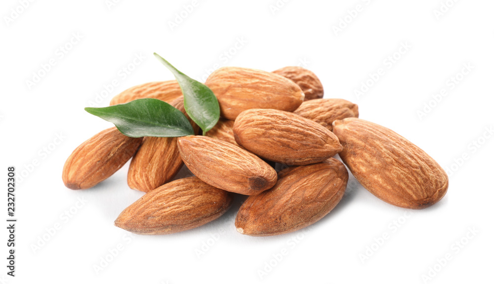 Organic almond nuts and leaves on white background. Healthy snack