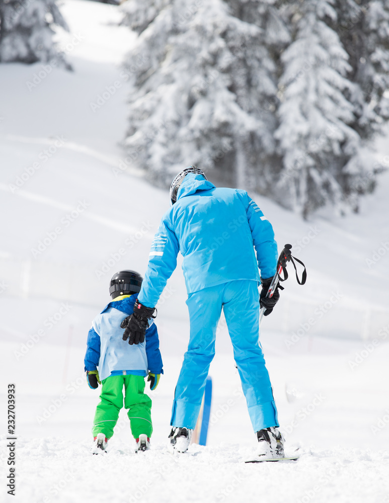 Child with teacher learning skiing