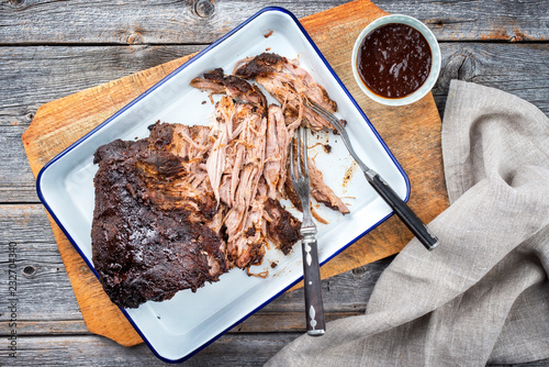 Traditional barbecue pulled pork piece of Bosten butt torn to bits as top view on a board photo