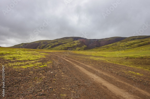Dirt road to Thjofadalir valley in Iceland highlands. Cloudy summer day.