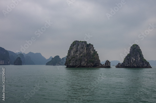 Beautiful limestone mountain scenery at Ha Long Bay  North Vietnam. Foggy weather in winter day.