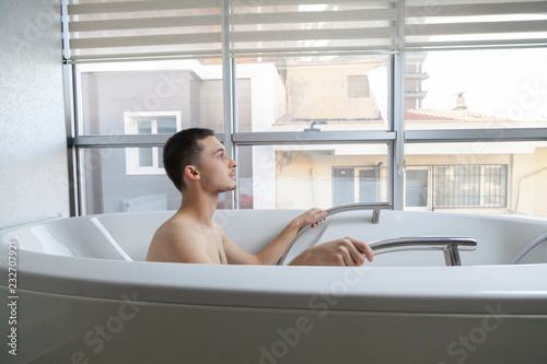 Patient doing some special exercises under supervision of physical therapist in a therapy bath tub