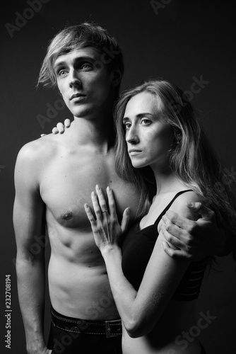 Studio shot of young couple together in black and white