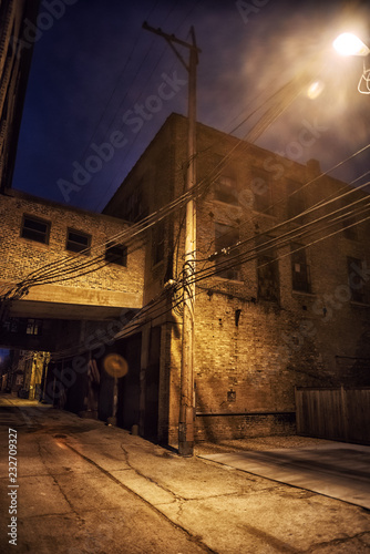 Dark and scary downtown urban city street alley scene with an ee