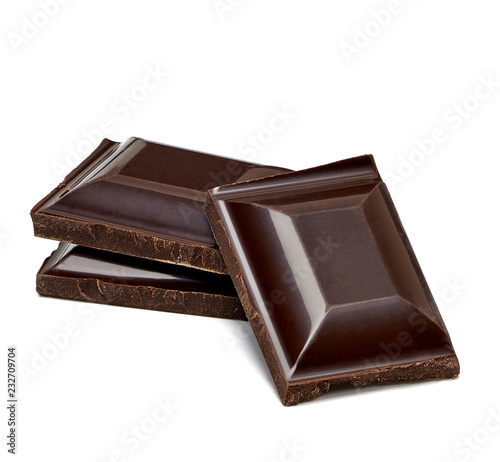 Dark chocolate bars or pieces stack isolated on white background photo