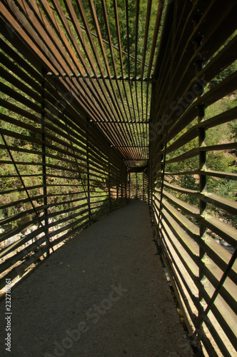 Lightweight wooden footbridge with covering in the Gorges de l'Areuses, Romandie photo