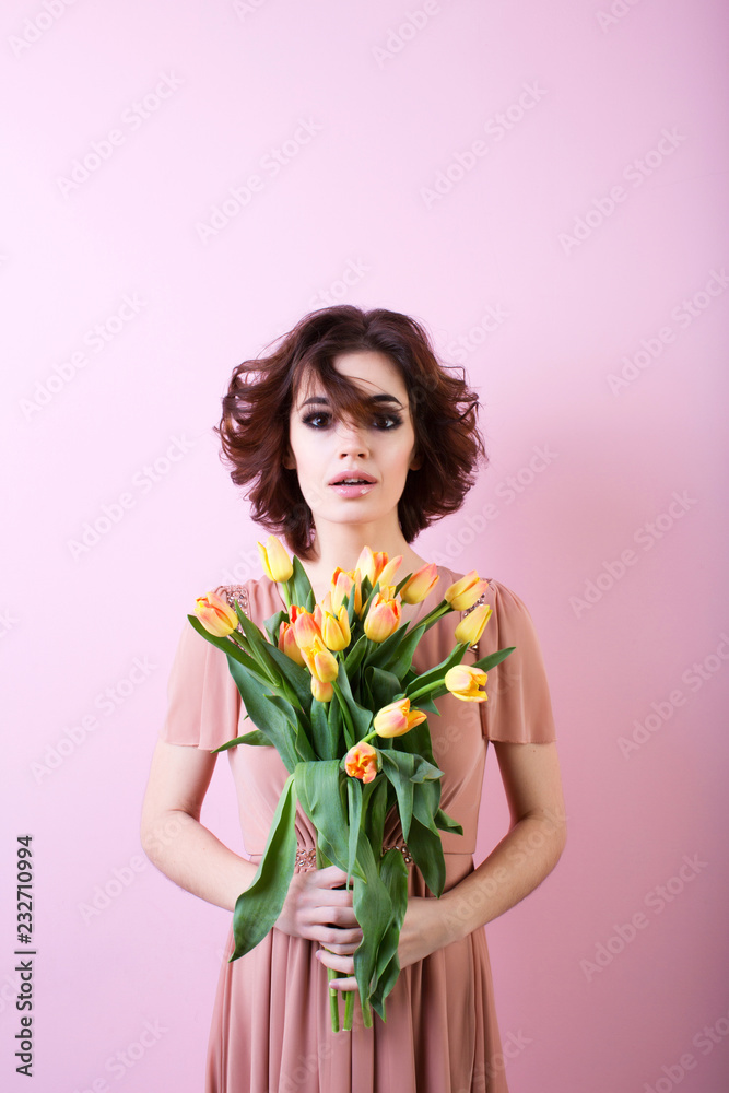 Surprised female with a bouquet of flowers over pink. Surprised female with a bouquet of flowers over pink.