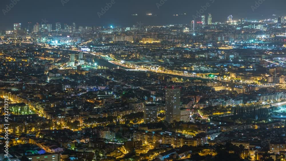 Barcelona and Badalona skyline with roofs of houses and sea on the horizon night timelapse