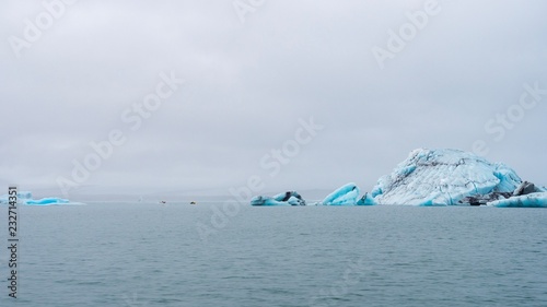 Enormous icebergs floating on a glacial lagoon in southeastern Iceland photo