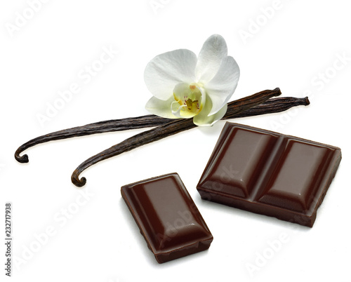 Broken or cracked dark chocolate bars, chips or pieces, vanilla beans and curl isolated on white background