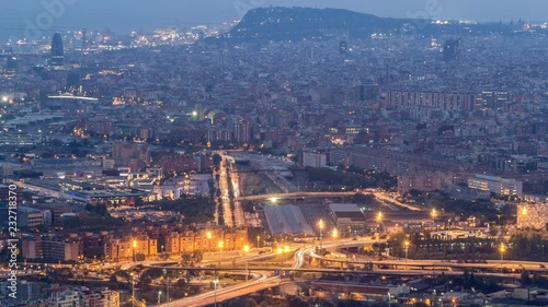 Barcelona and Badalona skyline with roofs of houses and sea on the horizon day to night timelapse photo