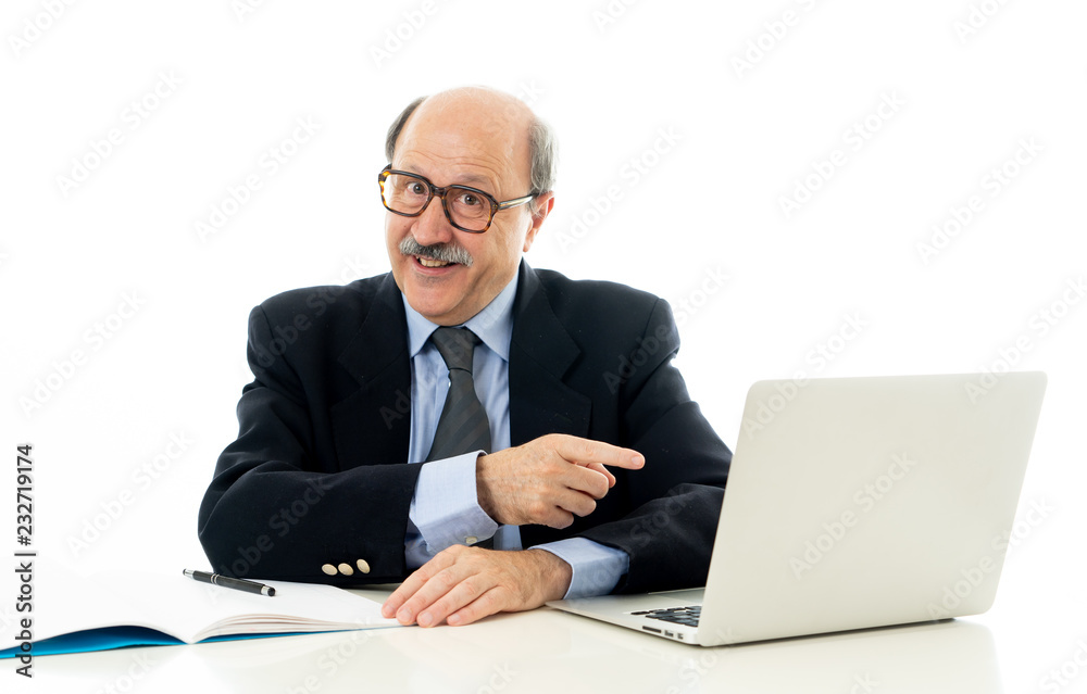 Pleased mature business man in his 60s working on laptop confident of success Pleased mature business man in his 60s working on laptop confident of success