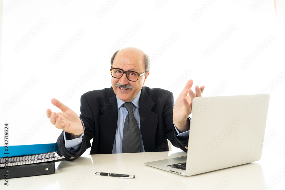 Pleased mature business man in his 60s working on laptop confident of success Pleased mature business man in his 60s working on laptop confident of success