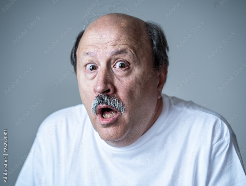 Close up of scared and shocked senior man gesturing in fear with hands and face Close up of scared and shocked senior man gesturing in fear with hands and face