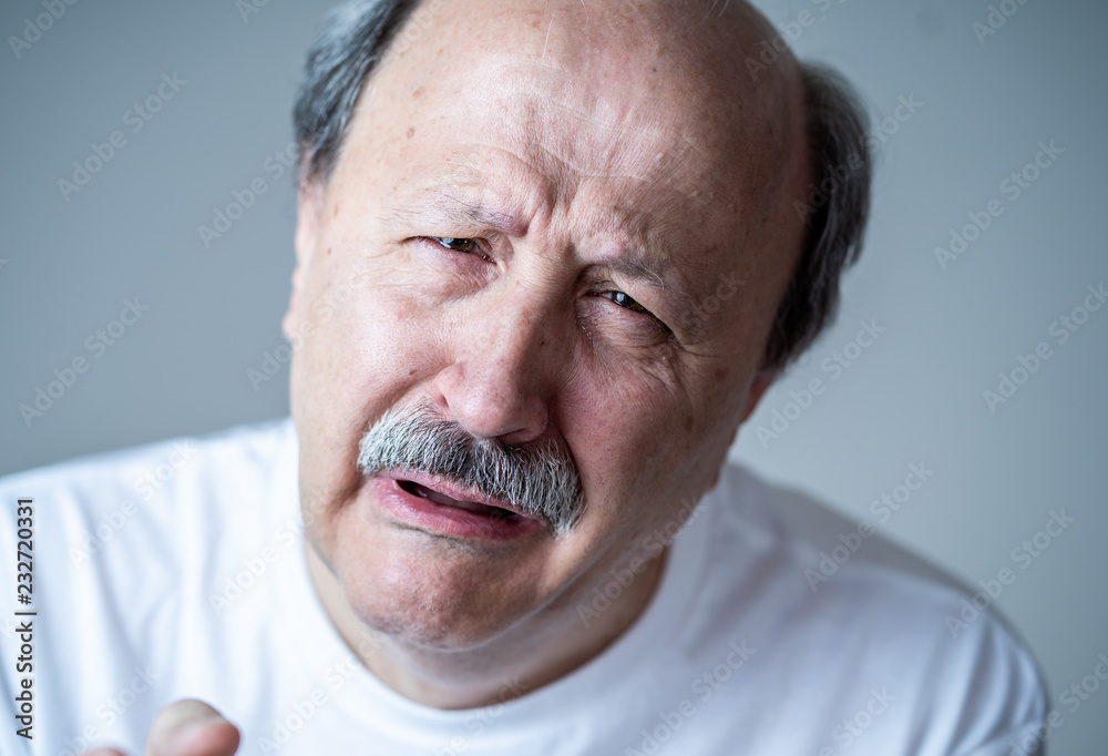 Close up portrait of sad old man face suffering from depression