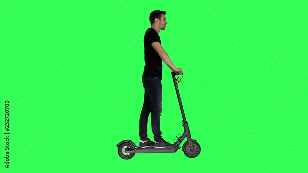 Riding an electric scooter by a casual looking young man over a green screen, Riding an electric scooter by a casual looking young man over a green screen,