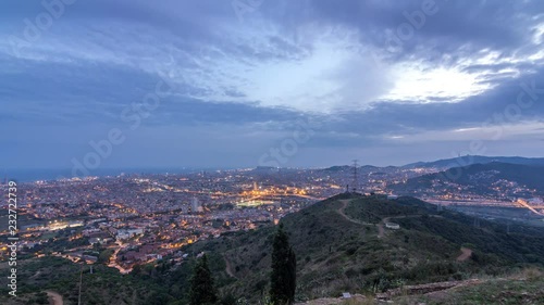 Barcelona and Badalona skyline with roofs of houses and sea on the horizon day to night timelapse photo