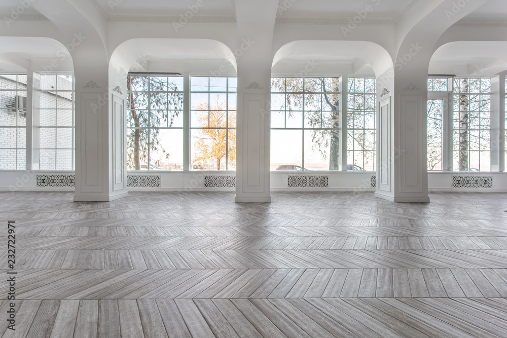 Morning in luxurious light interior in mansion . Bright and clean interior design of a luxury living room . Stucco on walls. High Windows and square columns Morning in luxurious light interior in mansion . Bright and clean interior design of a luxury living room . Stucco on walls. High Windows and square columns