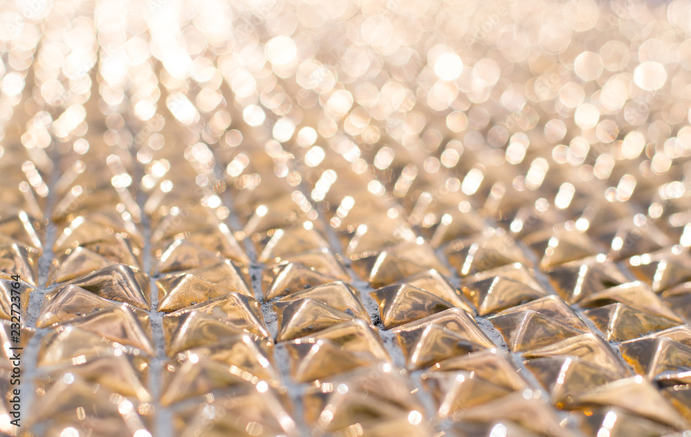 Fototapeta premium Abstract gold bokeh background, metal surface is not in focus