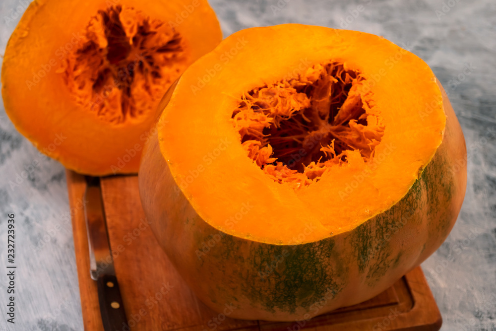 Slice of ripe pumpkin with orange flesh and fibers in the core. Slice of ripe pumpkin with orange flesh and fibers in the core.