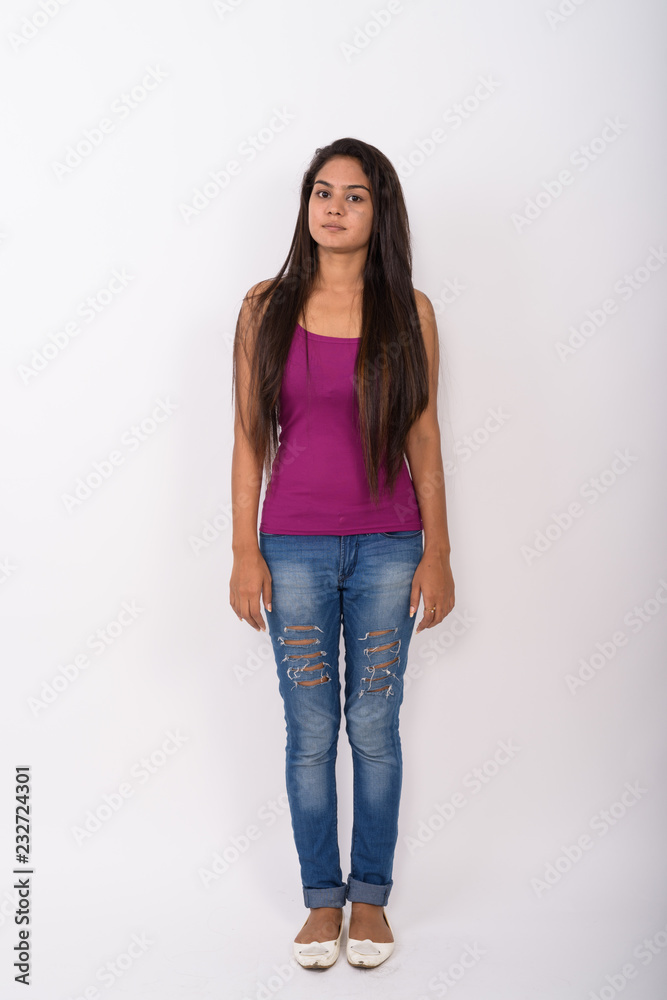 Full body shot of young Indian woman standing while wearing slee