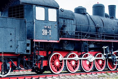 large old black and red steam locomotive, wheels of old steam locomotives. a pair of wheels. retro locomotives. vintage photo