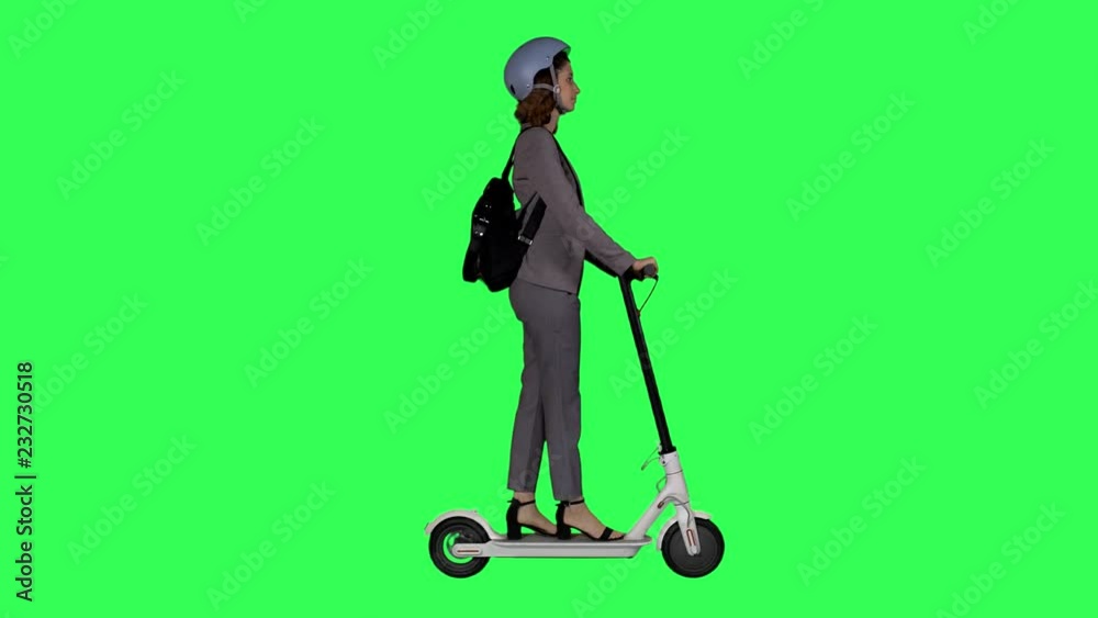 Riding an electric white scooter to work by a young businesswoman, wearing a helmet over a green screen, Riding an electric white scooter to work by a young businesswoman, wearing a helmet over a green screen,