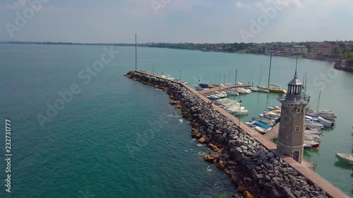Aerial view of boats and lighthouse in Lake Garda, Italy.