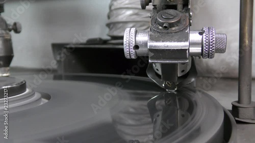 A diamond held by dop is polished on rotating automatic cast iron lap photo