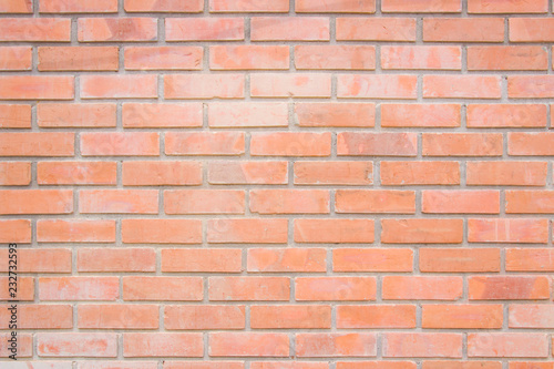 Orange brick wall texture background. Brickwork or stonework flooring interior rock old pattern clean concrete grid uneven bricks design stack.